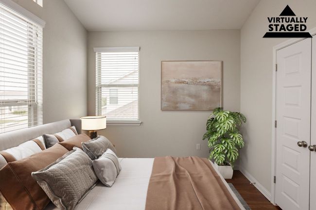 Bedroom with multiple windows and wood finished floors | Image 17