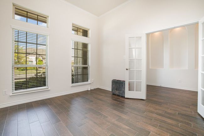 Empty room with french doors, baseboards, ornamental molding, and wood finished floors | Image 14