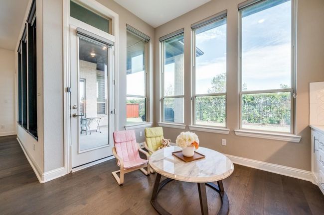 Sunroom with baseboards, wood finished floors, and plenty of natural light | Image 19