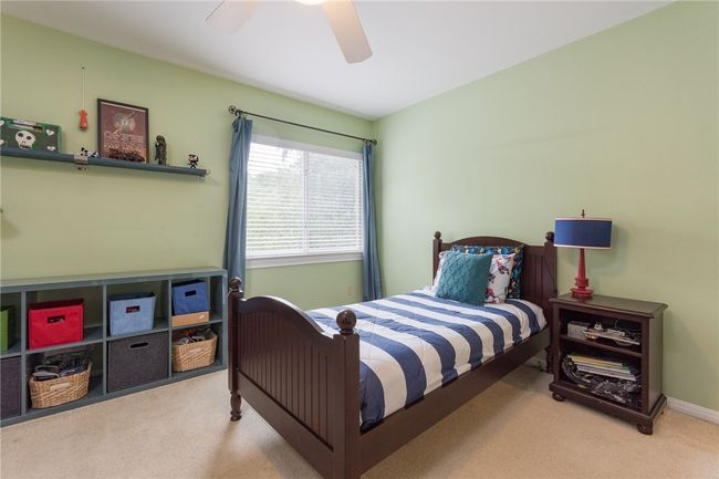 Carpeted bedroom featuring a ceiling fan | Image 22