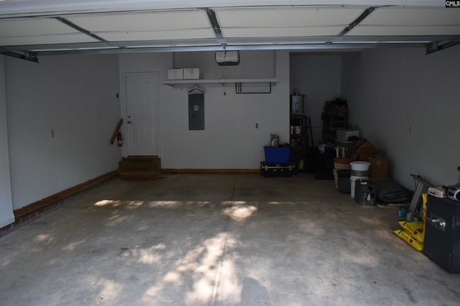 Lots of suspended storage over the garage door and wall going into house | Image 13