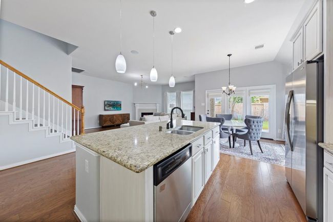 This open-concept layout effortlessly connects the kitchen, dining, and living areas, creating a spacious and inviting flow ideal for both everyday living and entertaining. | Image 10
