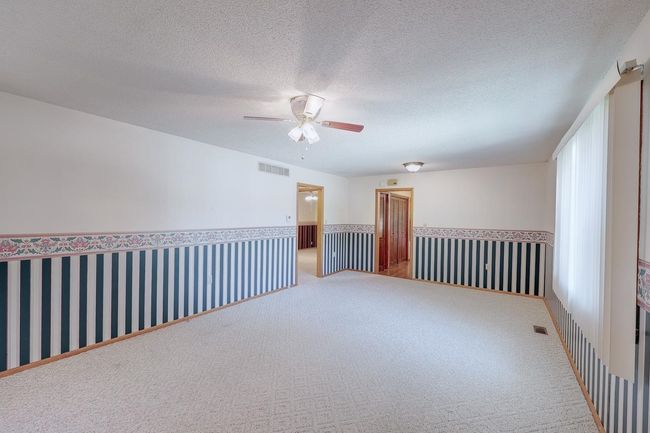 Carpeted spare room with a ceiling fan and a textured ceiling | Image 19