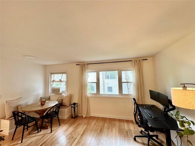 Home office with wood finished floors and baseboards | Image 7