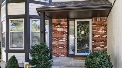 View of front of home featuring a garage and a front yard | Image 2