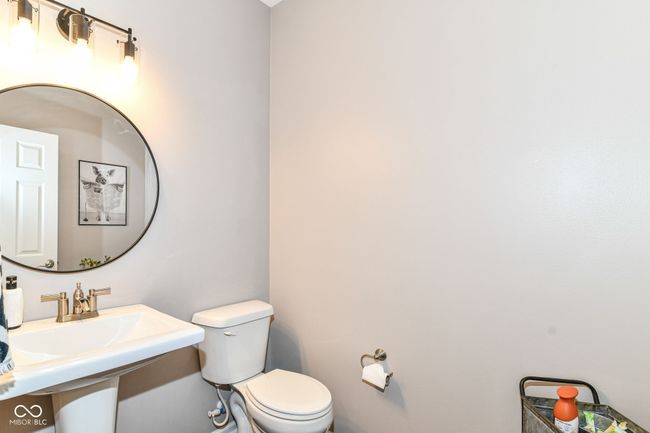 bathroom featuring toilet and a sink | Image 23