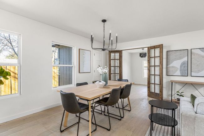 Dining area featuring a chandelier and light wood-style floors | Image 9
