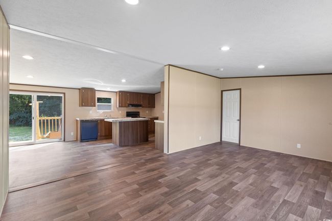Unfurnished living room featuring recessed lighting and dark wood-type flooring | Image 9