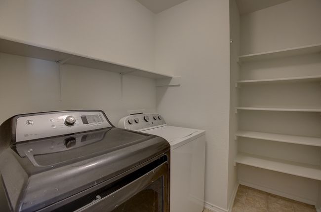 Laundry room featuring independent washer and dryer and baseboards | Image 9
