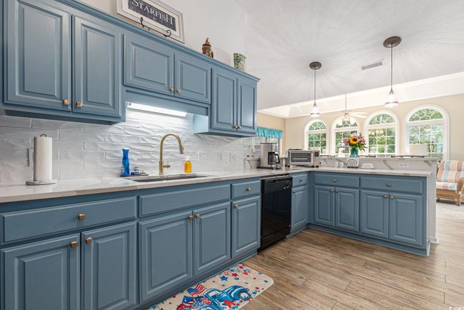 Kitchen featuring blue cabinets, dishwasher, and a sink | Image 19