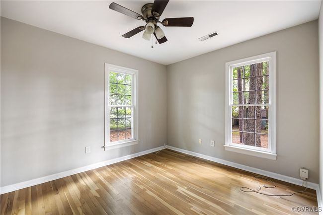 First floor bedroom room featuring hardwood flooring and a ceiling fan | Image 12