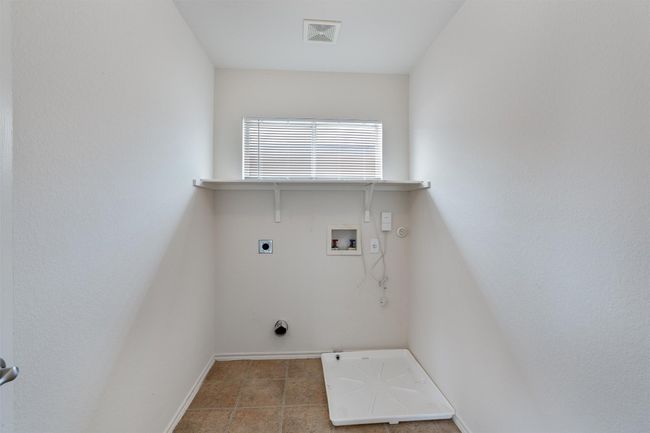 Washroom featuring gas dryer hookup, hookup for an electric dryer, washer hookup, and baseboards | Image 18