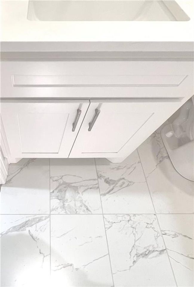 Detailed view of vanity and beautiful tiled floors | Image 32