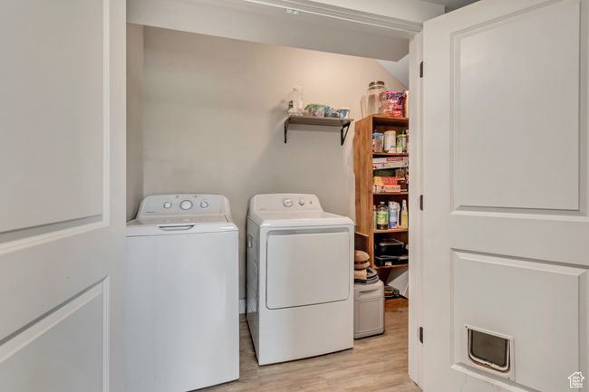 Laundry room with independent washer and dryer and light wood-style flooring | Image 9