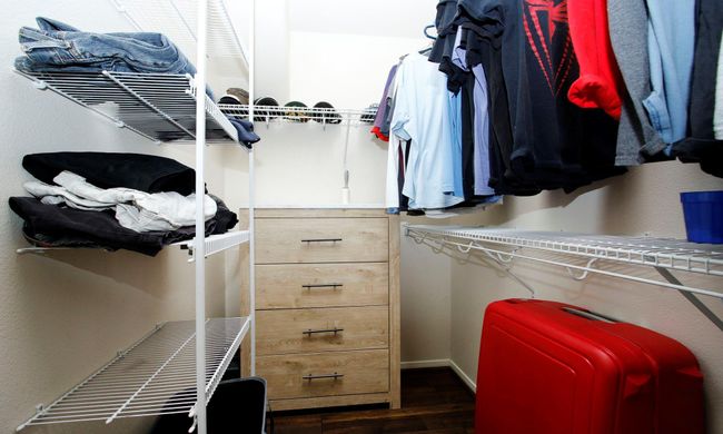 Primary closet with built in racks for storage. | Image 12