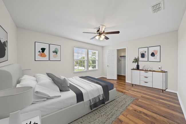 Bedroom with wood finished floors, a ceiling fan, and a walk in closet | Image 28