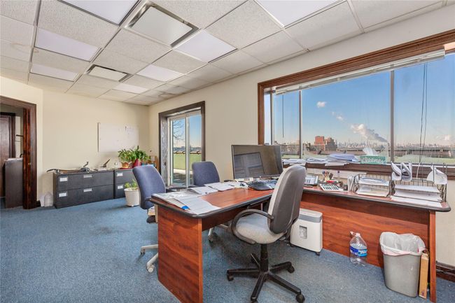Office area with a paneled ceiling and carpet flooring | Image 33