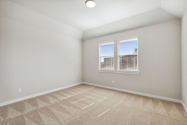 Empty room with light colored carpet, vaulted ceiling, and baseboards | Image 13