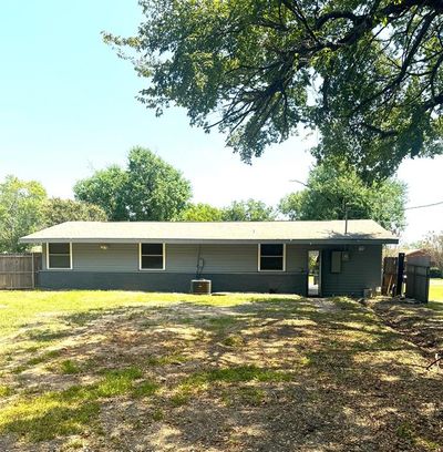 Rear view of property with central air condition unit and a lawn | Image 2