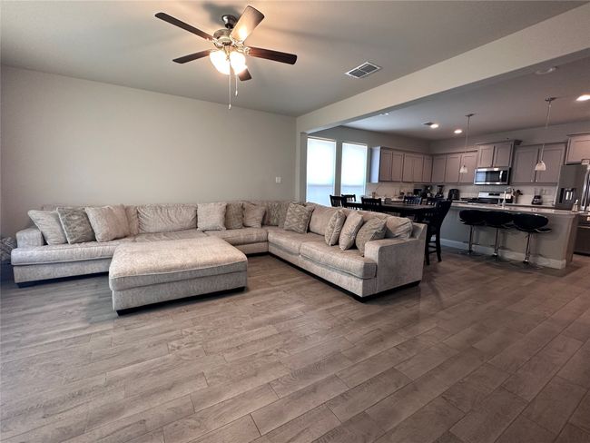 Living area with wood finished floors, recessed lighting, and a ceiling fan | Image 10
