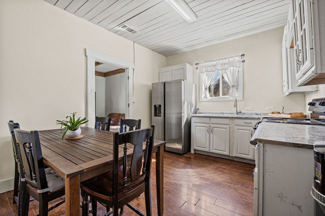 Dining space featuring wooden ceiling, visible vents, and dark wood finished floors | Image 11