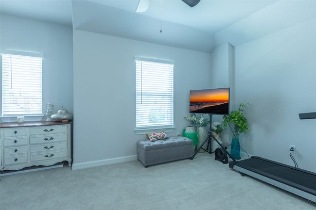Sitting room with light carpet and a ceiling fan | Image 29