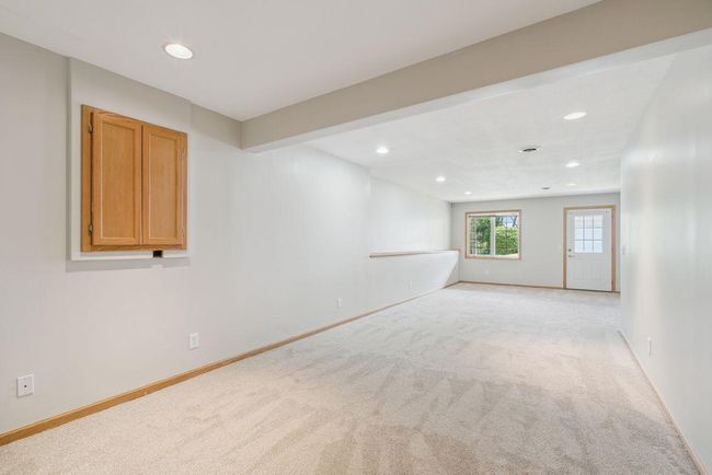 Large (34x13) walkout lower level family room, freshly painted, new carpet, outside leads to back patio, recessed lights. | Image 21