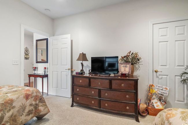 Bedroom featuring light colored carpet | Image 6