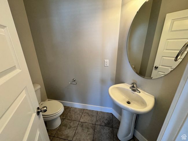 Half bath featuring toilet, tile patterned floors, and baseboards | Image 4