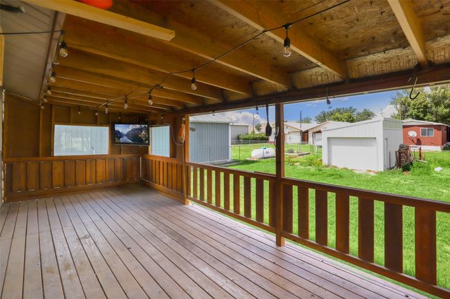 Wooden deck featuring an outbuilding | Image 35