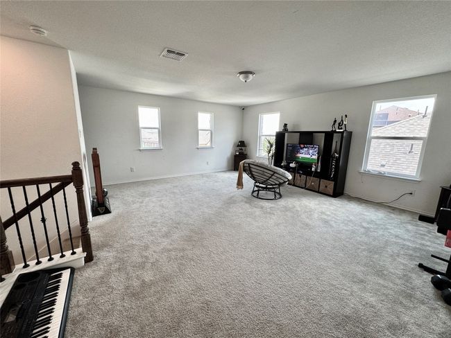 Living area featuring carpet flooring and a textured ceiling | Image 23