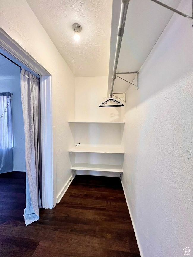 Walk in closet featuring wood finished floors | Image 23