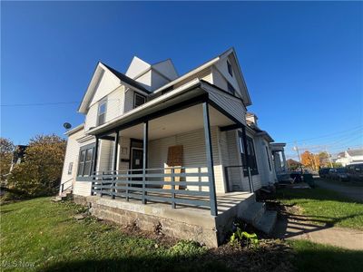 View of side of home with a lawn and a porch | Image 3