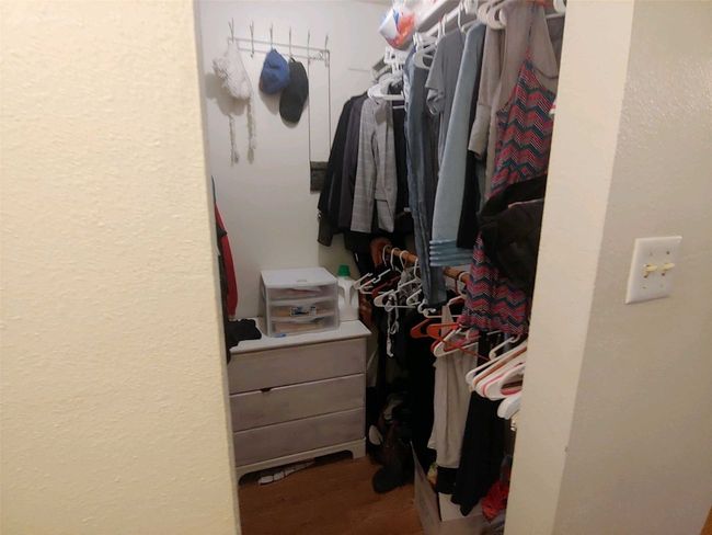 Spacious closet featuring wood finished floors | Image 13