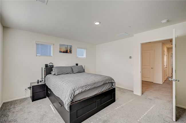 Bedroom featuring light colored carpet and baseboards | Image 15