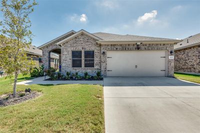 View of front facade featuring a front yard and a garage | Image 2