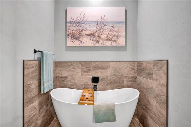 Bathroom with a soaking tub and tile walls | Image 31