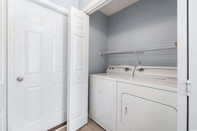 Washroom with independent washer and dryer and light wood finished floors | Image 19