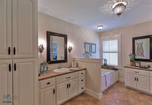 Full bath featuring vanity and a bath | Image 27