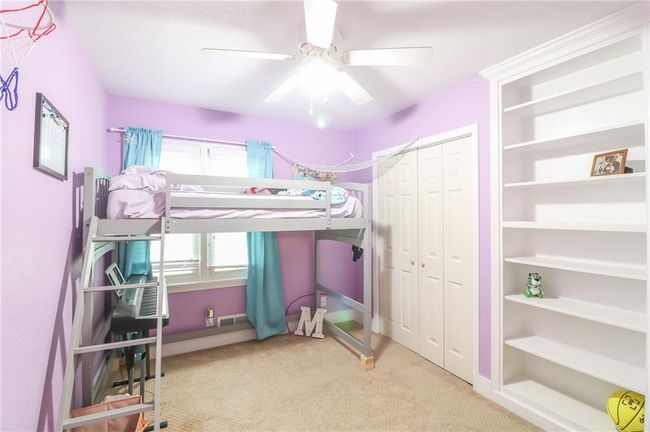 Bedroom with carpet floors, a closet, and a ceiling fan | Image 31
