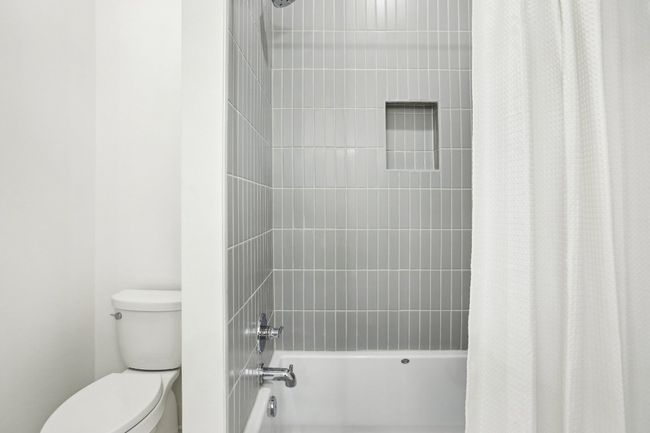 Indulge in spa-level comfort with a deep soaking tub and oversized walk-in shower. | Image 29