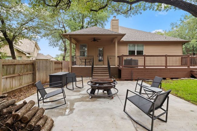 View of patio with a fire pit, ceiling fan, and a deck | Image 33