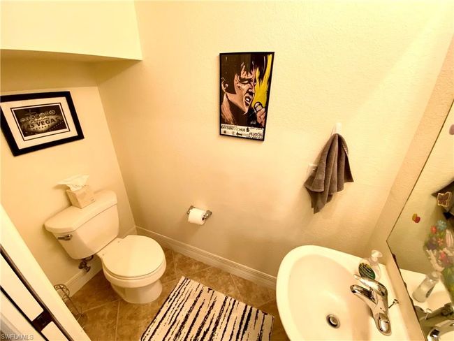 Bathroom featuring toilet, baseboards, a sink, and tile patterned floors | Image 6