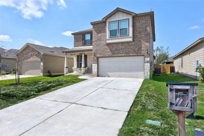 This home in Jarrell, TX, sits in a quiet neighborhood and is located near a local park, offer. With a spacious front yard, it’s ready for your family. | Image 3