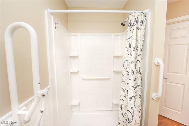 Bathroom featuring wood finished floors and a shower with curtain | Image 20