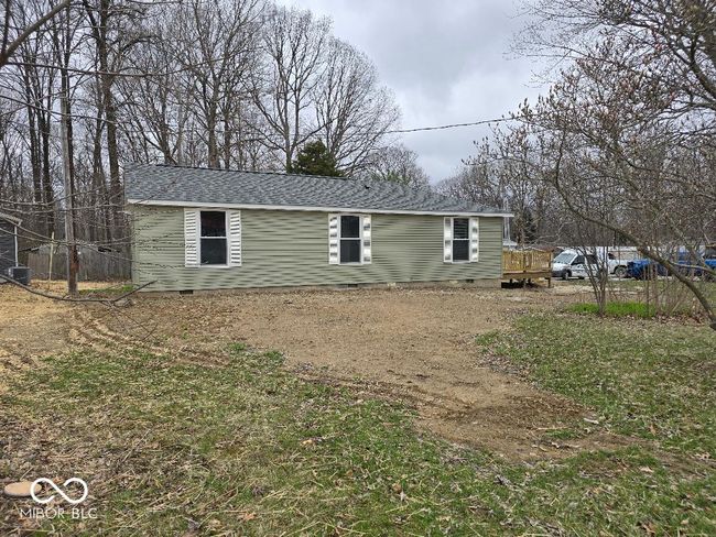 view of front of home featuring a shingled roof, central AC, and crawl space | Image 7