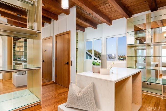 Off master suite, spacious walk-in closet #2, featuring electronic drop-down clothing rods for ultimate convenience. | Image 39