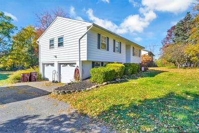 View of home's exterior featuring a garage and a yard | Image 3