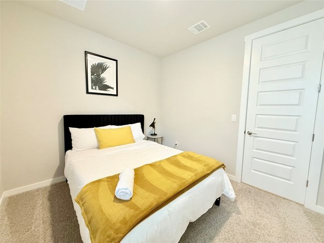 Carpeted bedroom featuring baseboards and visible vents | Image 28