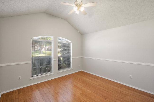 Front bedroom featuring wood finished floors, ceiling fan, and vaulted ceiling | Image 18
